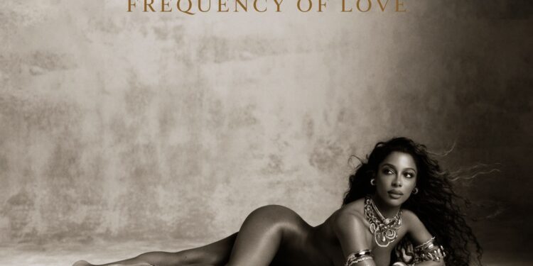 Official cover art for Victoria Monét's album Frequency of Love, a sepia-toned portrait of Monét reclining on the floor in layered gold jewelry beneath the album title